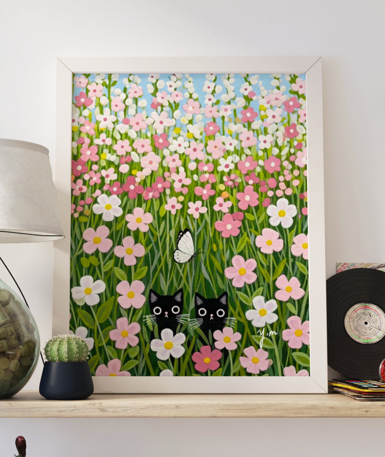 A whimsical pastel art print featuring two black cats hiding playfully in a pink flower field, with a small butterfly fluttering nearby. Soft, dreamy tones make this illustration perfect for nurseries, kids' rooms, or any cozy, cat-loving space.