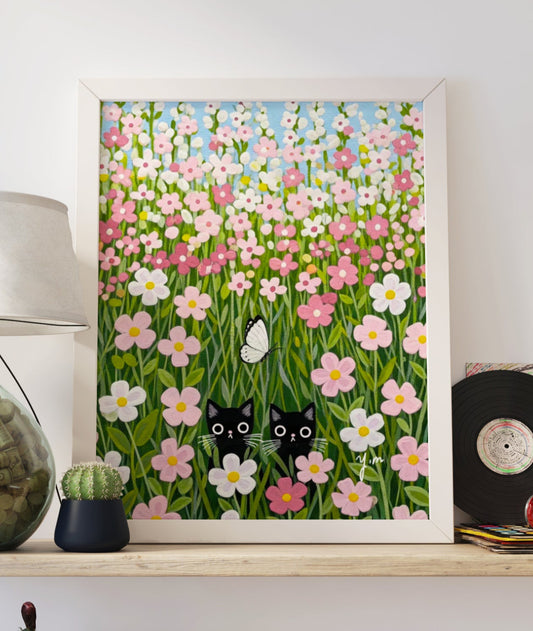 A whimsical pastel art print featuring two black cats hiding playfully in a pink flower field, with a small butterfly fluttering nearby. Soft, dreamy tones make this illustration perfect for nurseries, kids' rooms, or any cozy, cat-loving space.