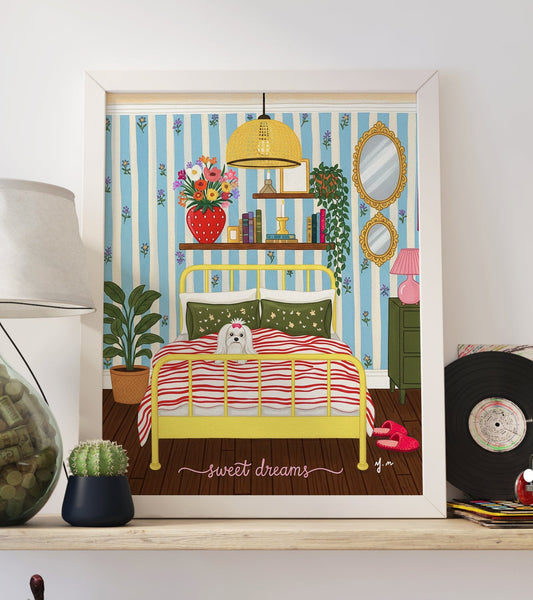 A fluffy white Maltese dog with a pink bow lies in a yellow bed with red striped bedding and green pillows, surrounded by pastel floral wallpaper, a green nightstand with a pink lamp, framed mirrors, a hanging light, books, and plants. The scene is cozy, vintage-inspired, and perfect for dog lovers.