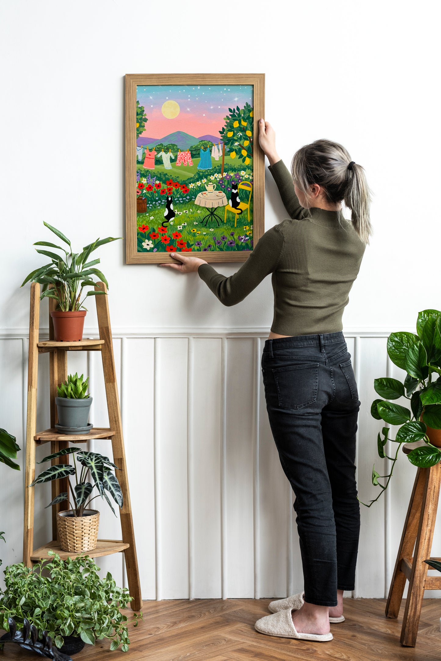 Two cats having tea at sunset with a laundry line in the background and a whimsical landscape scene perfect for cozy home wall decor