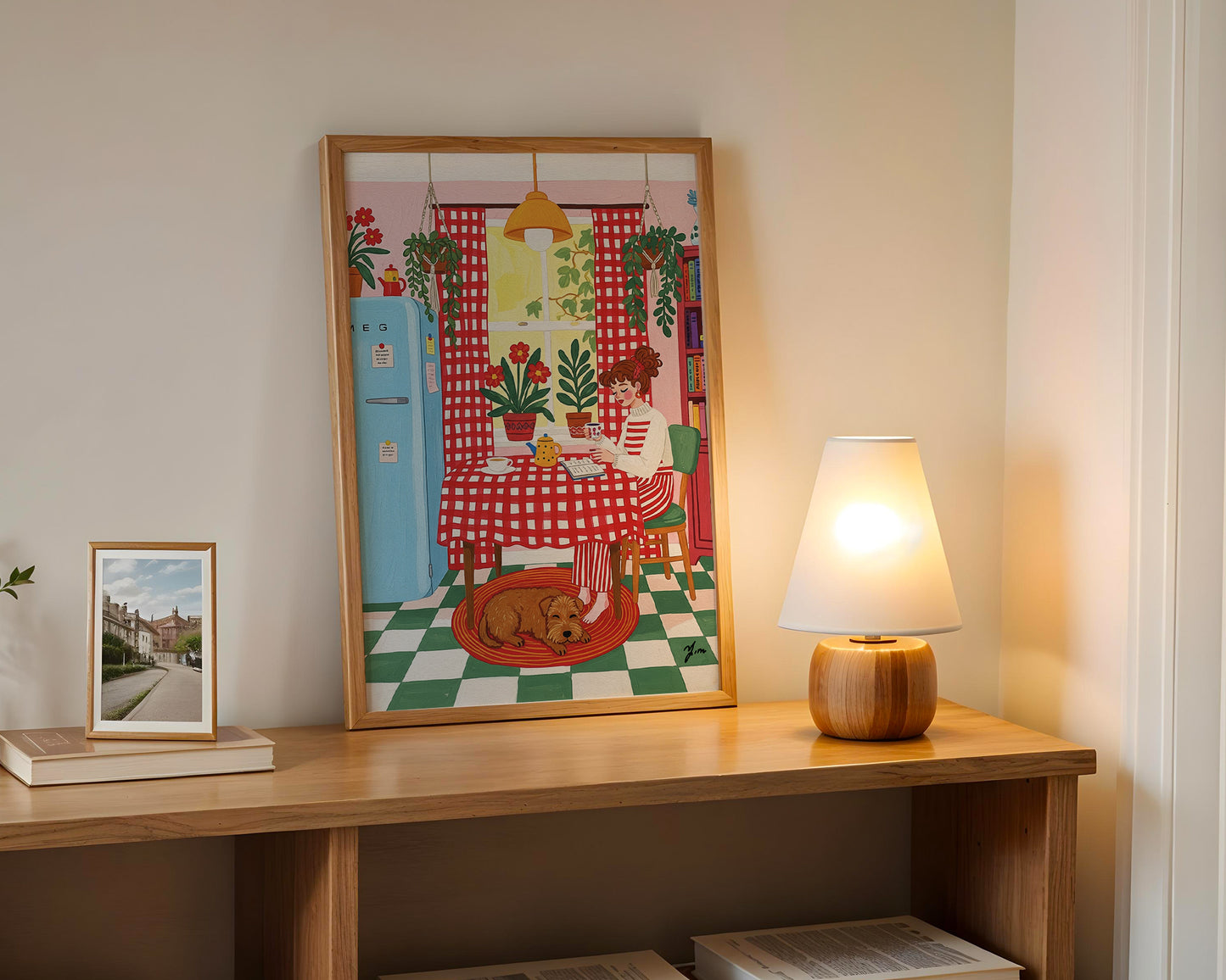 Cozy kitchen illustration with red checkered curtains, vintage blue fridge, potted plants, and a brown dog resting on a rug.