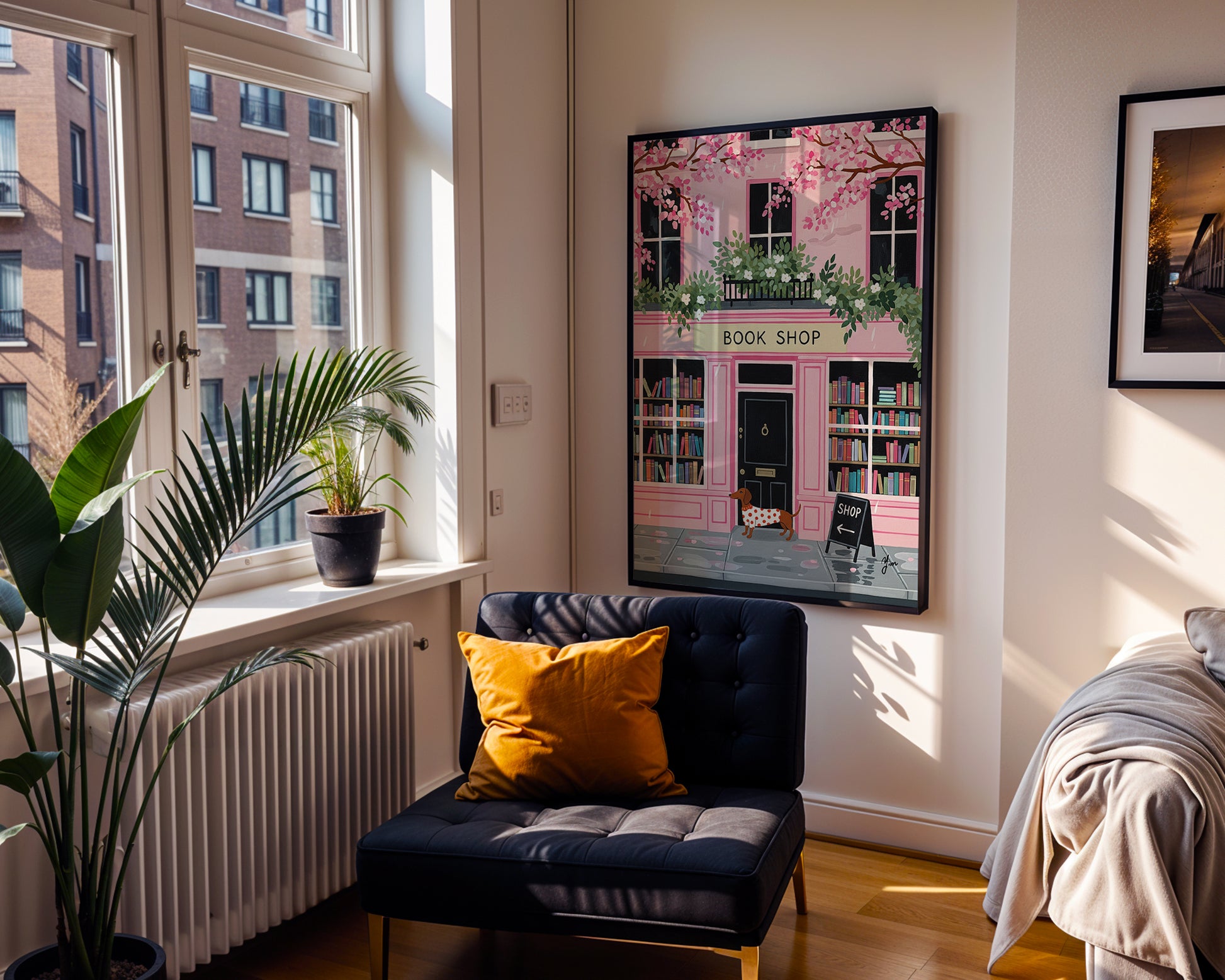 Dachshund in red polka dot sweater standing in front of pink bookshop with cherry blossoms and books
