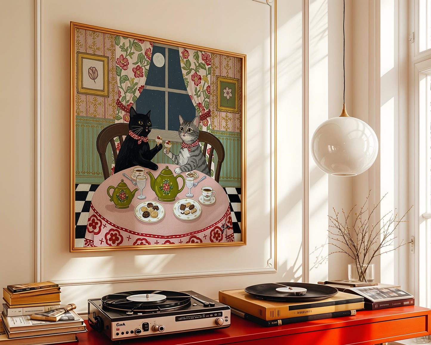 Two cats wearing red bows sit at a floral-covered table enjoying tea and desserts under a full moon in a vintage-style room with flowered curtains and teacups.