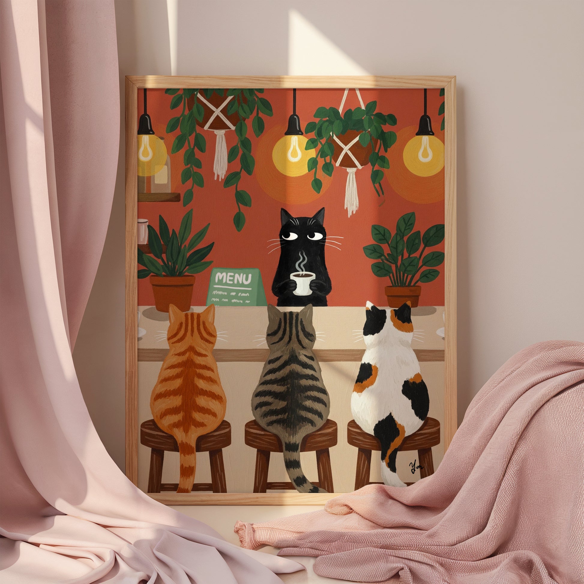 A whimsical illustration of a cozy cat café scene where three cats—a ginger tabby, a gray striped tabby, and a calico—sit on wooden stools at a coffee bar. A black cat barista stands behind the counter holding a steaming cup of coffee. The café is warmly lit with glowing hanging bulbs and decorated with lush green potted and hanging plants. The background features an earthy orange-red wall, creating a comforting and inviting atmosphere.